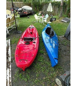 Wilderness systems and old Town kayaks,with paddles and wheeled tote.